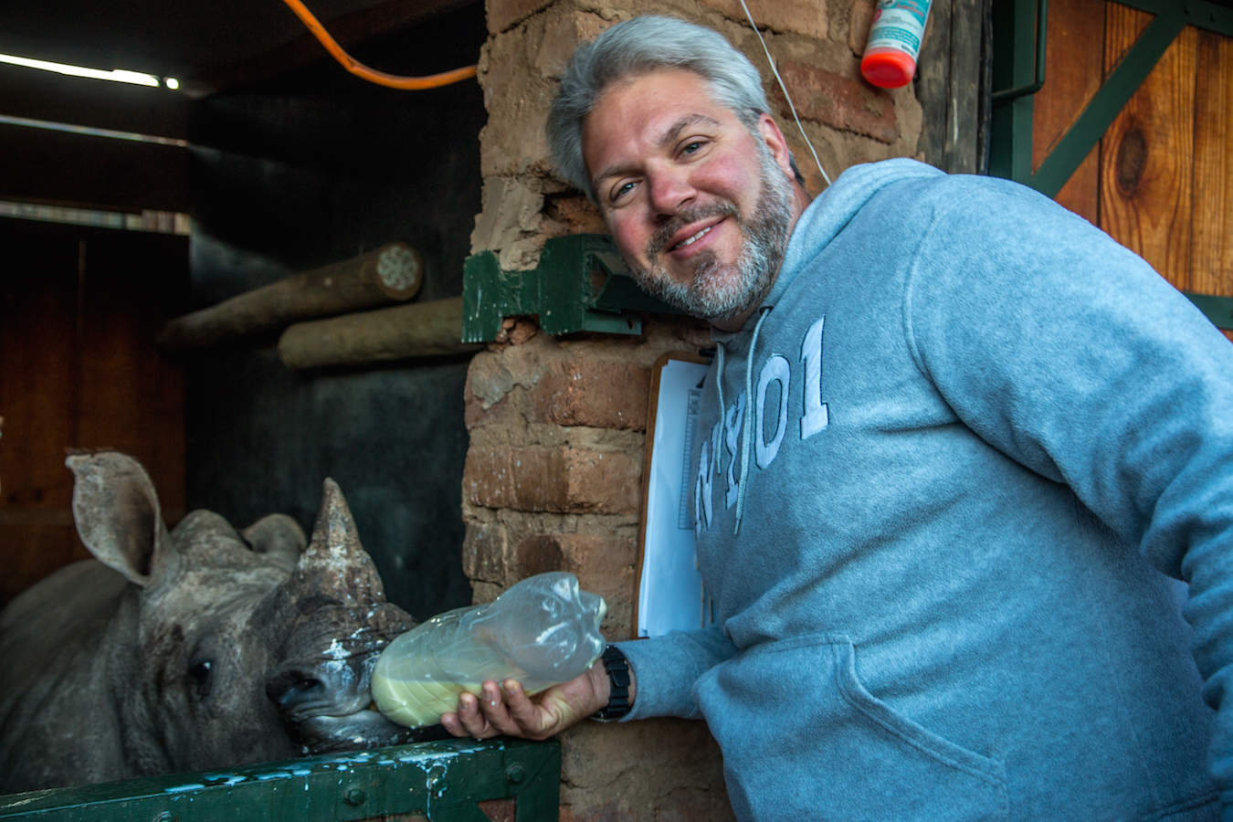 Bret Love of Green Global Travel feeding Baby Rhino at Care for Wild Africa